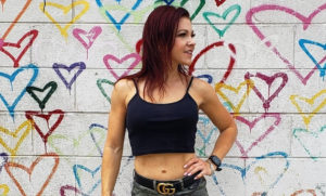 Erin Good posing in front of the Union Market hearts mural in D.C.