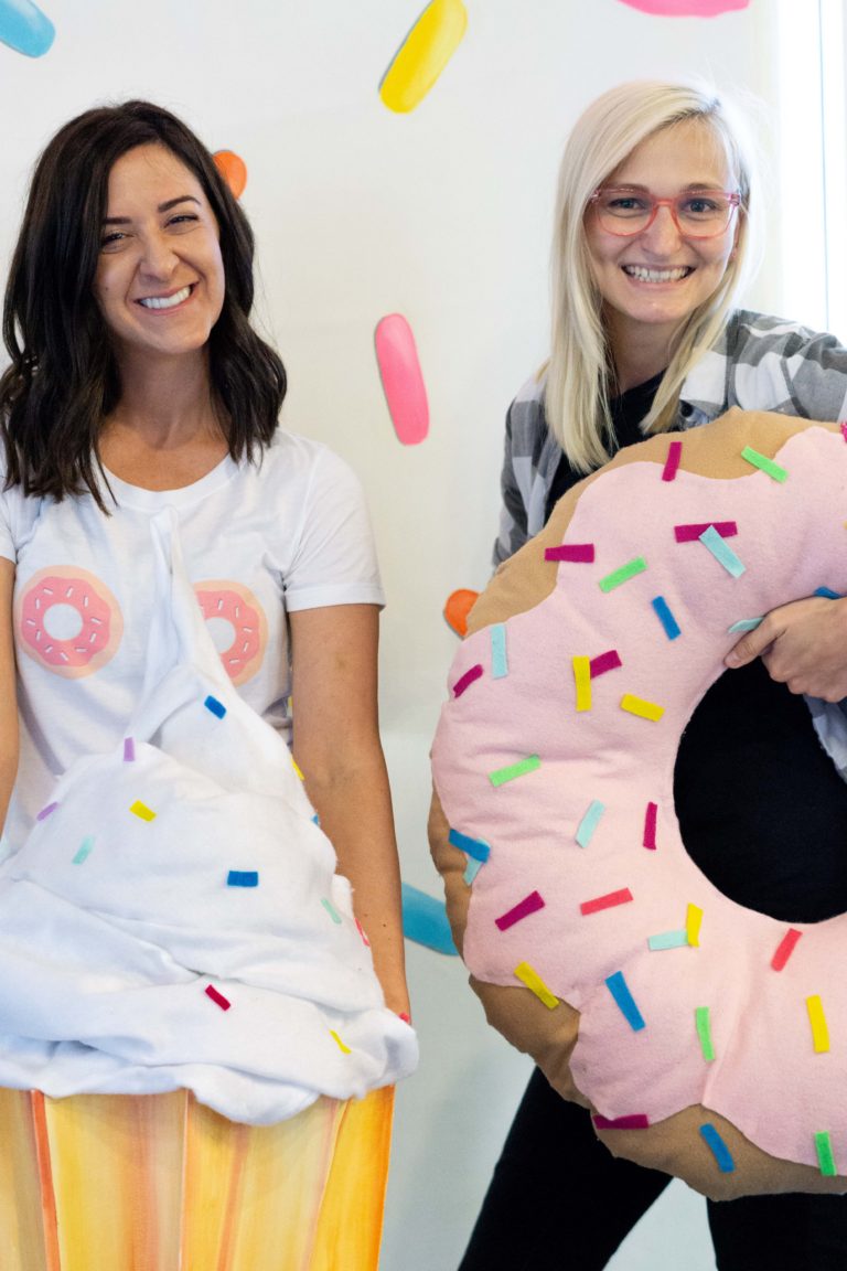 Rory and Volta in front of the sprinkled donut wall