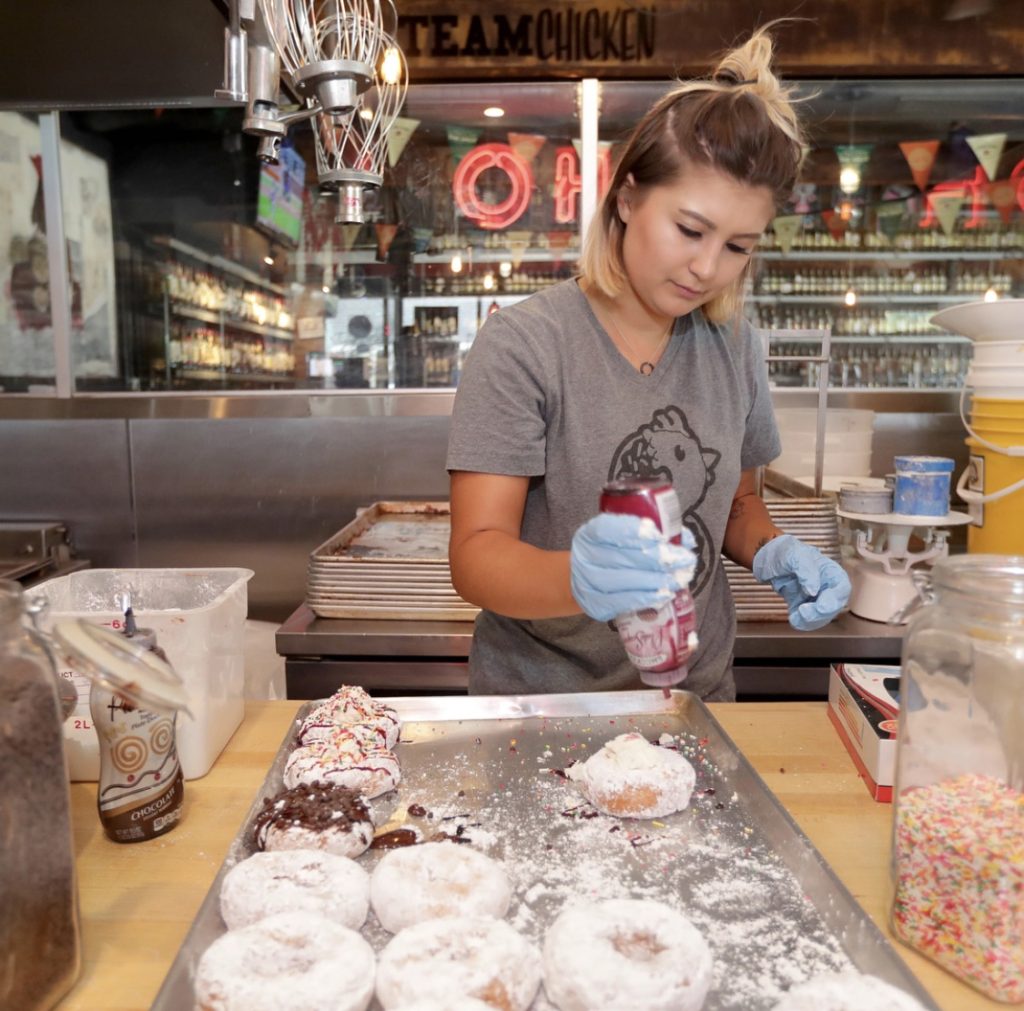 Rachael Cholak decorating donuts at Mike's Donuts - Kenosha, Wisconsin